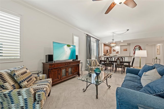 living room featuring crown molding, light parquet flooring, and ceiling fan