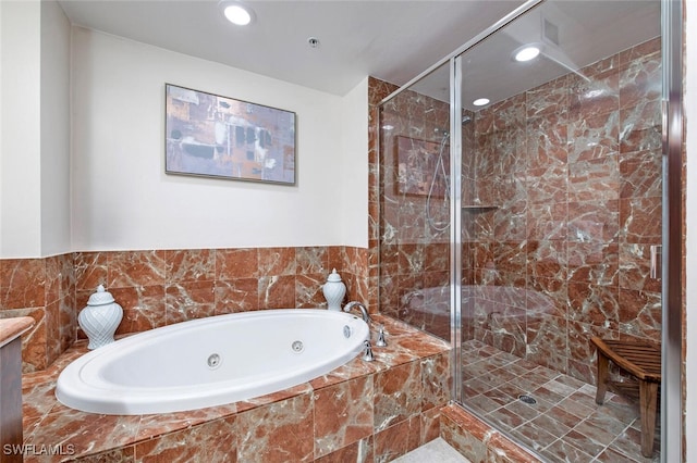 bathroom featuring separate shower and tub