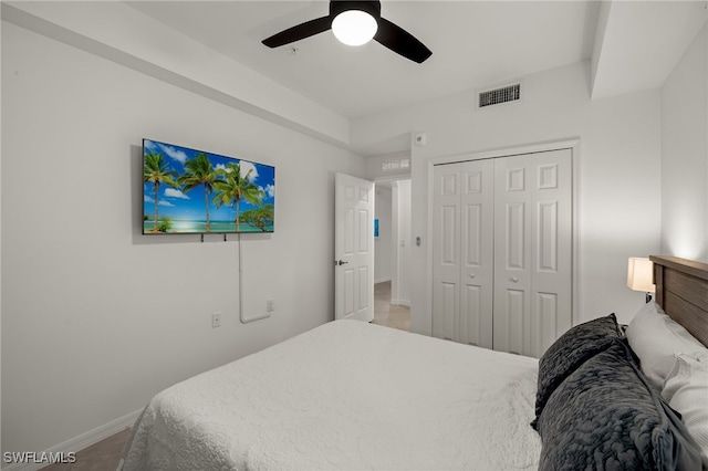 bedroom with ceiling fan and a closet