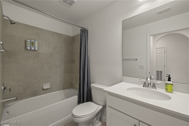 full bathroom featuring shower / tub combo with curtain, vanity, and toilet