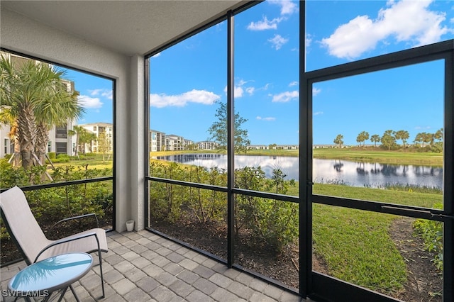 unfurnished sunroom featuring a water view