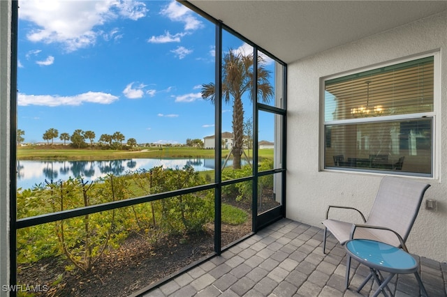 unfurnished sunroom with a water view