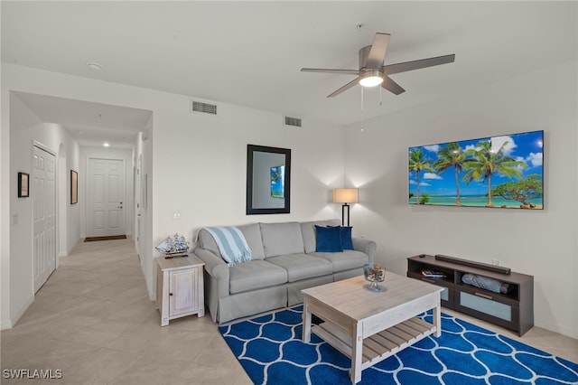 living room featuring light tile patterned floors and ceiling fan