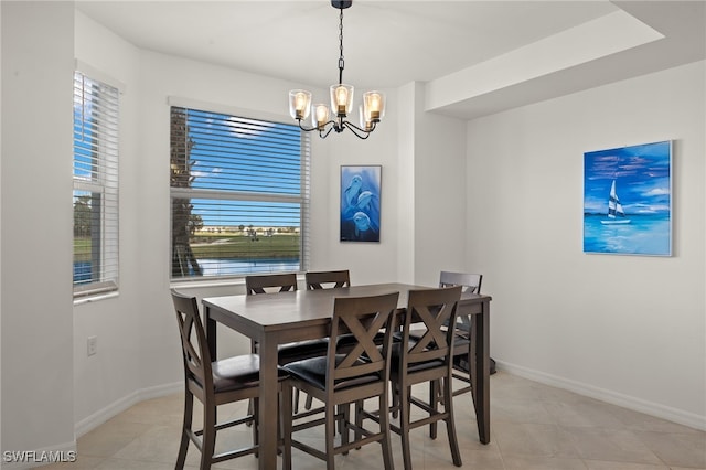 tiled dining area featuring a chandelier