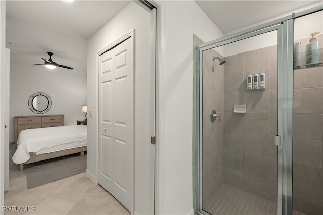 bathroom featuring tile patterned flooring, ceiling fan, and walk in shower