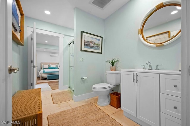 bathroom featuring toilet, vanity, an AC wall unit, walk in shower, and tile patterned floors