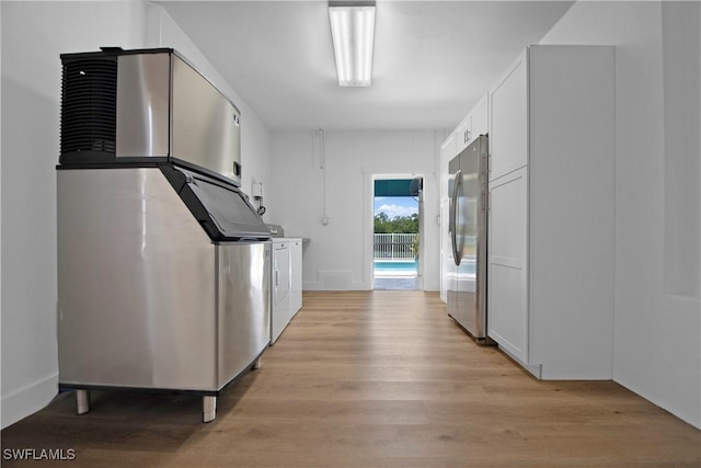 corridor with light hardwood / wood-style floors