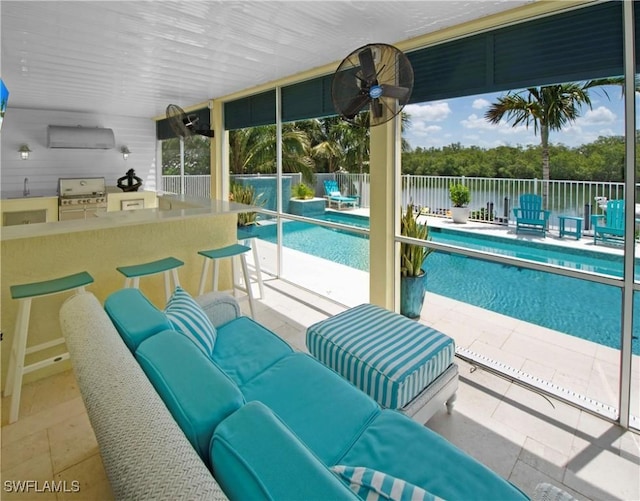 view of pool with ceiling fan, a bar, a patio area, and area for grilling