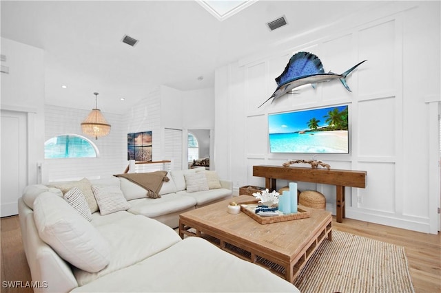 living room featuring a wealth of natural light and light hardwood / wood-style floors