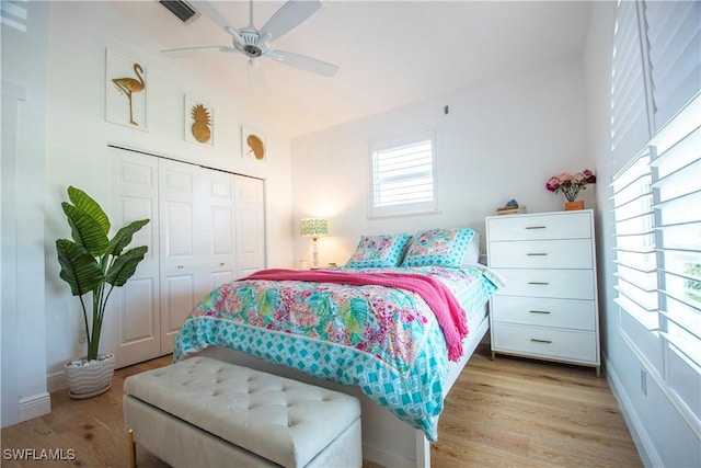 bedroom featuring a closet, light hardwood / wood-style flooring, and ceiling fan