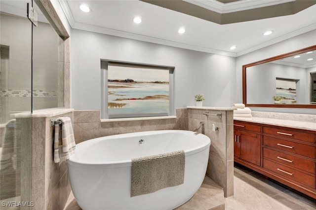 bathroom with tile walls, a bath, and vanity