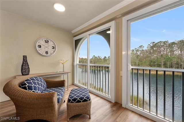 sunroom / solarium featuring a water view