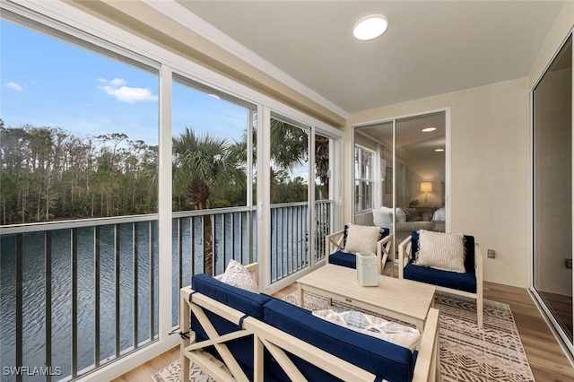 sunroom / solarium featuring a water view