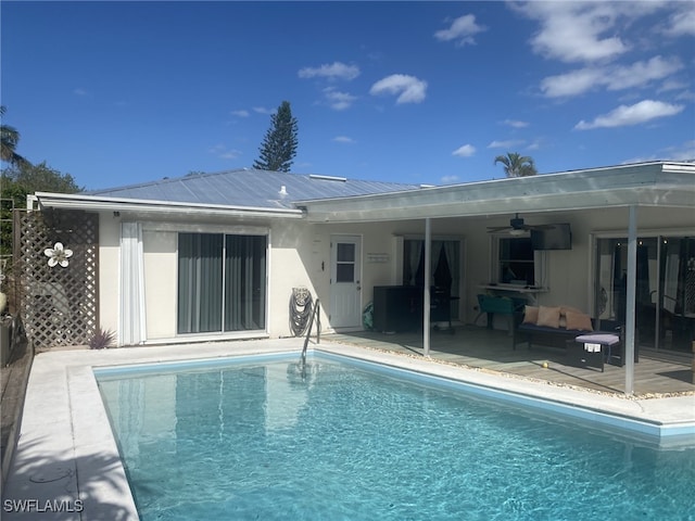 rear view of house with ceiling fan and a patio area