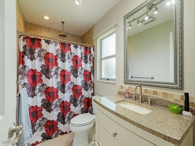 bathroom featuring toilet, vanity, and walk in shower