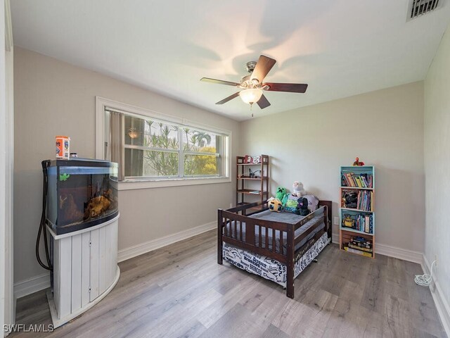 bedroom with ceiling fan and light hardwood / wood-style flooring