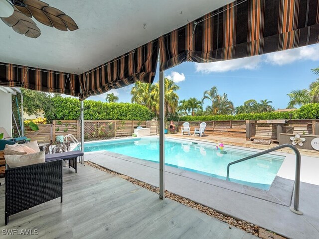 view of swimming pool featuring ceiling fan