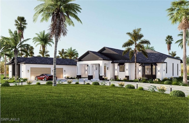 view of front of home featuring a front yard, driveway, an attached garage, and stucco siding