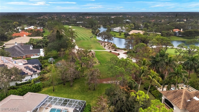 bird's eye view featuring golf course view, a water view, and a residential view