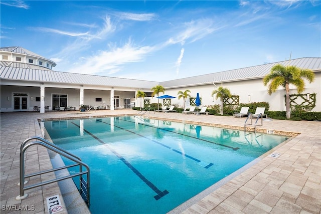 view of pool with a patio and french doors