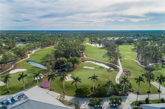 aerial view with view of golf course and a water view