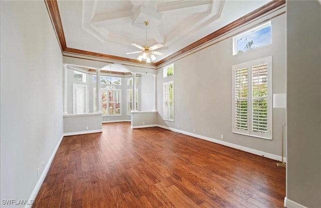 empty room featuring crown molding, ceiling fan, wood finished floors, coffered ceiling, and baseboards