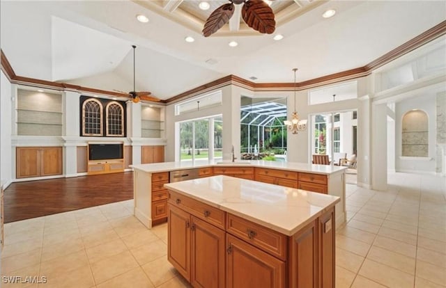 kitchen featuring light tile patterned floors, a center island, open floor plan, and ceiling fan with notable chandelier