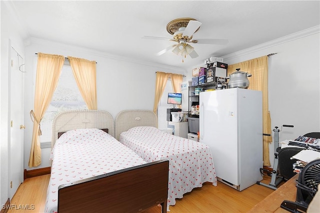 bedroom with ornamental molding, white refrigerator, ceiling fan, and light hardwood / wood-style flooring