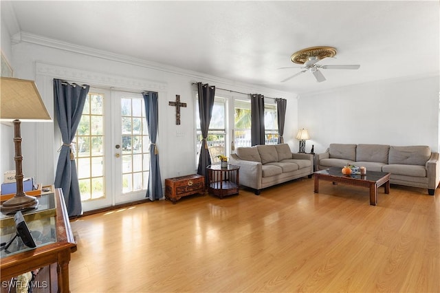 living room featuring crown molding, ceiling fan, french doors, and light hardwood / wood-style flooring