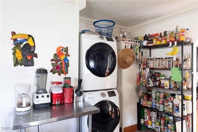 washroom featuring stacked washer / drying machine and ornamental molding