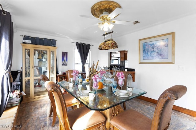 dining area with ceiling fan, ornamental molding, and dark parquet floors