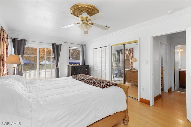 bedroom with ceiling fan, ornamental molding, access to exterior, two closets, and light hardwood / wood-style flooring