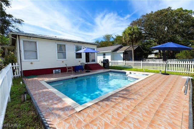 view of swimming pool with a patio area and grilling area