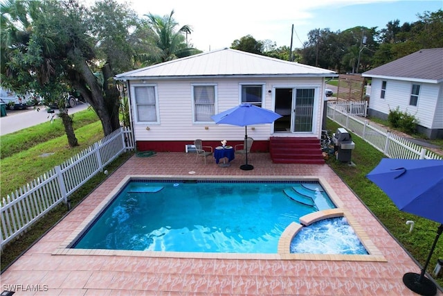 rear view of house featuring a patio area and a fenced in pool