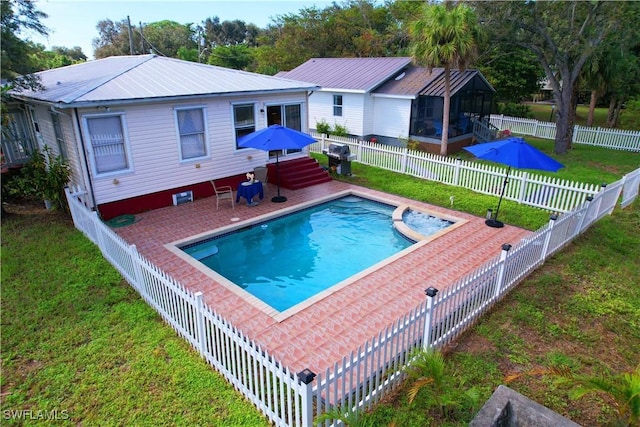 view of pool featuring a lawn