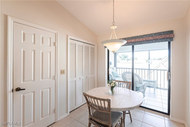 tiled dining space with vaulted ceiling