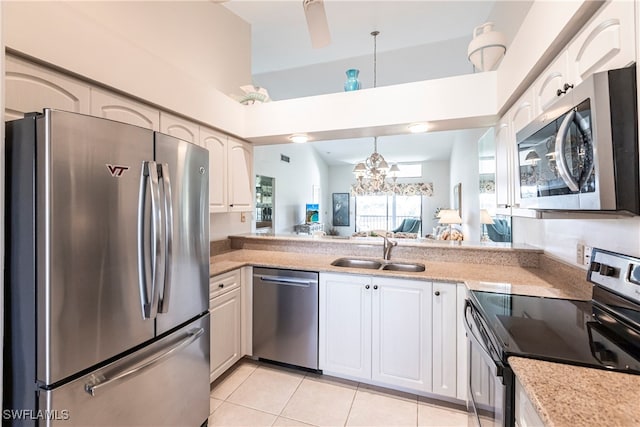 kitchen featuring sink, light tile patterned floors, stainless steel appliances, and white cabinets