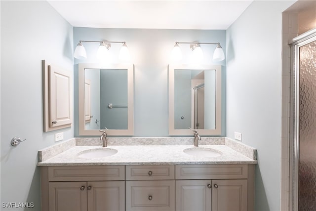 bathroom featuring vanity and a shower with shower door