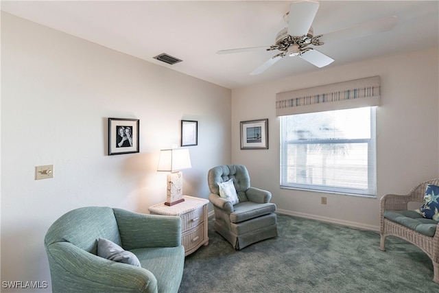 living area with carpet and ceiling fan