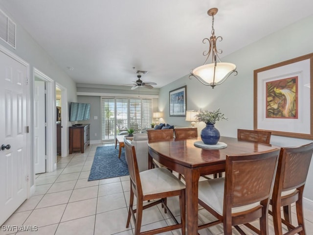 tiled dining space with ceiling fan