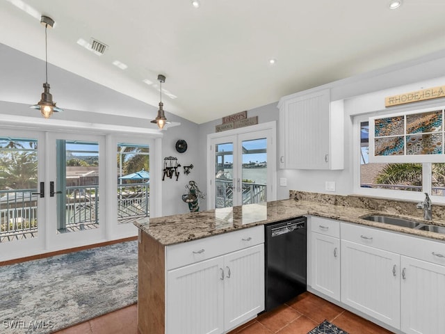 kitchen featuring decorative light fixtures, sink, black dishwasher, and lofted ceiling