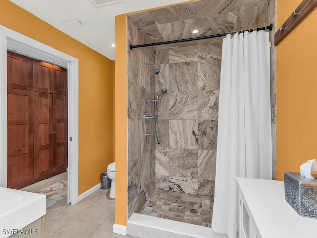 bathroom featuring tile patterned flooring, vanity, a shower with curtain, and toilet