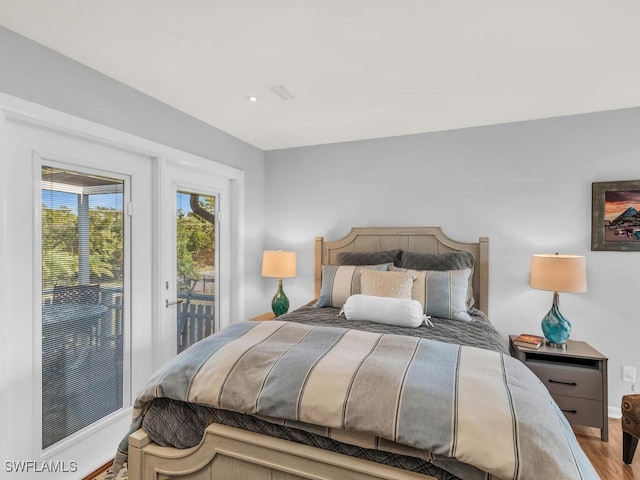 bedroom with light hardwood / wood-style flooring and access to outside