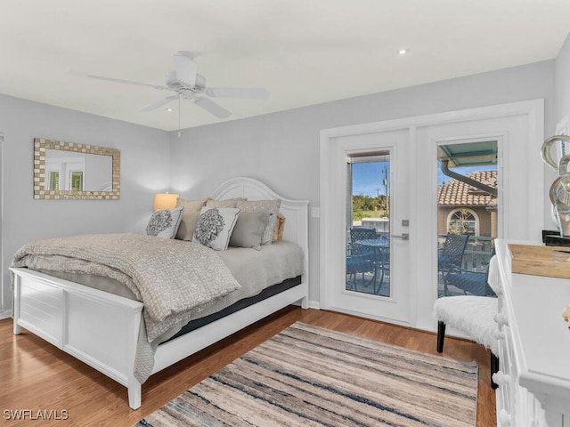 bedroom with dark wood-type flooring, ceiling fan, and access to outside