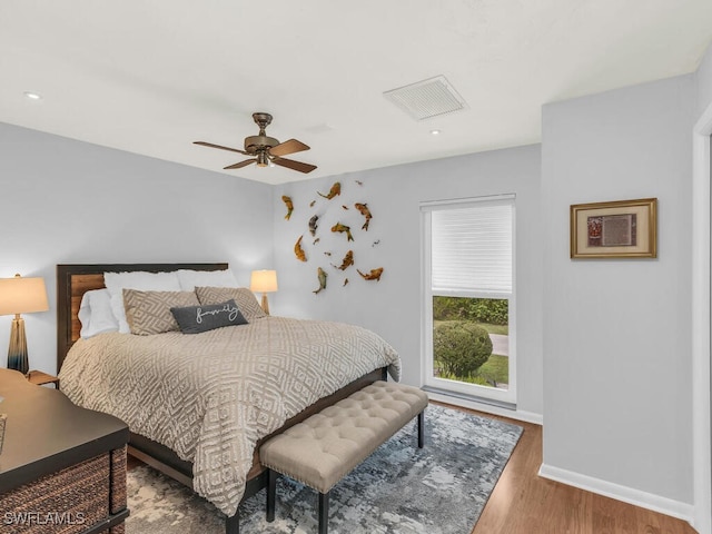 bedroom with ceiling fan and hardwood / wood-style floors