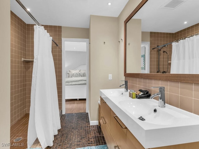 bathroom with decorative backsplash, curtained shower, tile patterned floors, and vanity