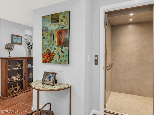 corridor featuring tile patterned floors and elevator