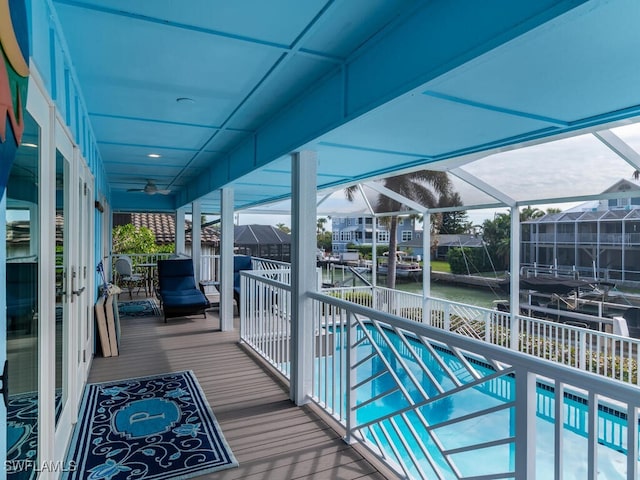 balcony featuring ceiling fan and a water view