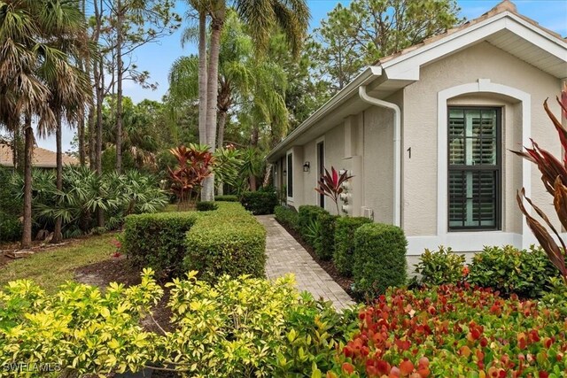 7590 Meadow Lakes Dr Unit 3201, Naples, FL 34104 - view of property exterior with stucco siding