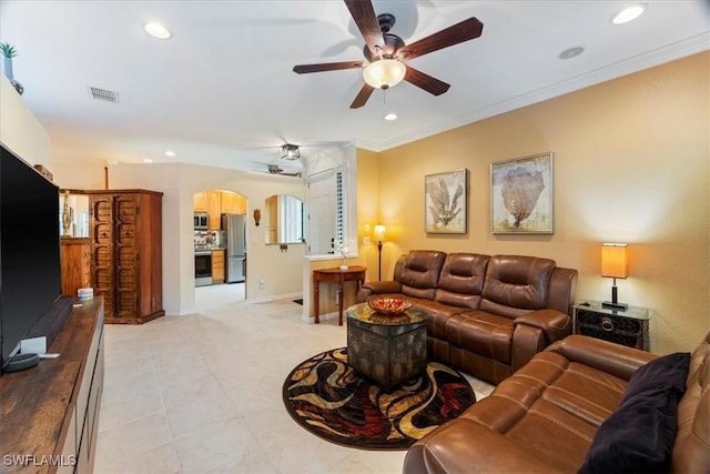 living room with ornamental molding and ceiling fan